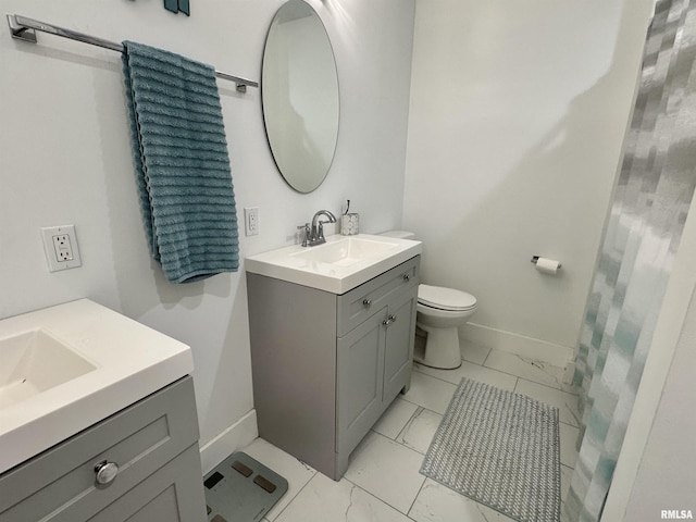 631 S Mcarthur St, Macomb, IL 61455 - full bath with marble look tile flooring, vanity, baseboards, and toilet
