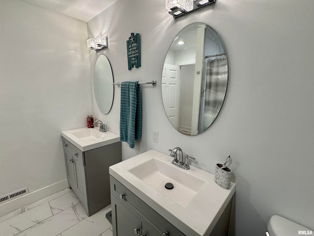 bathroom with vanity and toilet