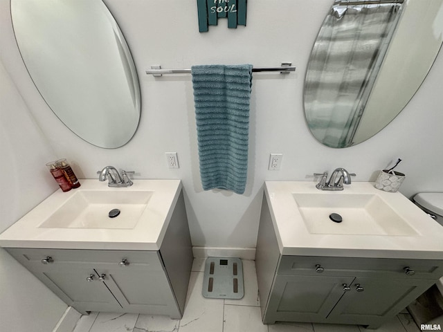 631 S Mcarthur St, Macomb, IL 61455 - bathroom featuring baseboards, vanity, and marble finish floors