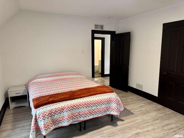 631 S Mcarthur St, Macomb, IL 61455 - bedroom with light wood-type flooring, baseboards, and lofted ceiling