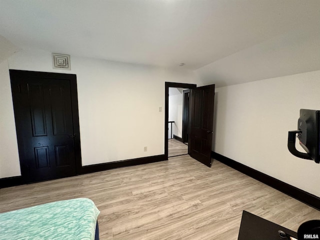 631 S Mcarthur St, Macomb, IL 61455 - bedroom with vaulted ceiling, baseboards, and light wood finished floors