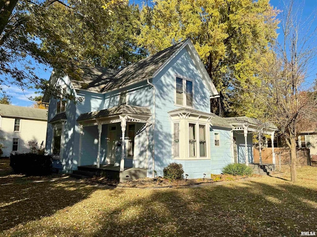 view of front of home with a pergola and a front yard