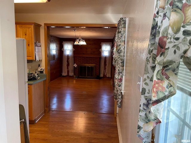 hall featuring dark wood-type flooring and a chandelier