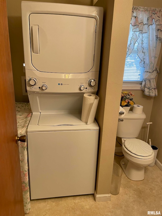 clothes washing area with stacked washer / dryer