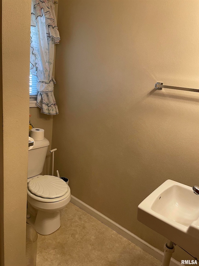 bathroom with toilet and sink