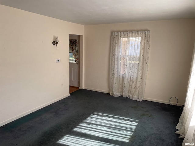 empty room with dark colored carpet