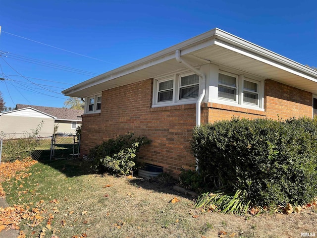 view of side of property with a lawn