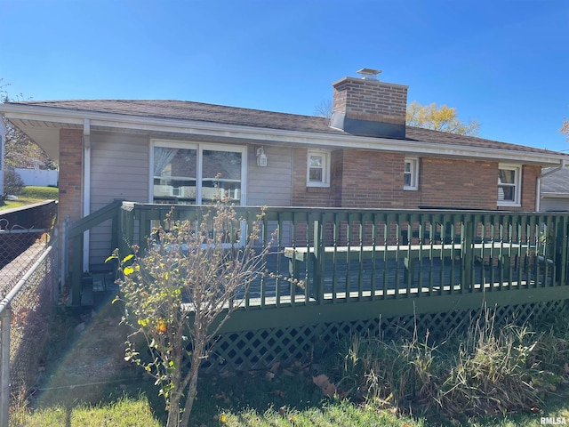 back of property featuring a wooden deck