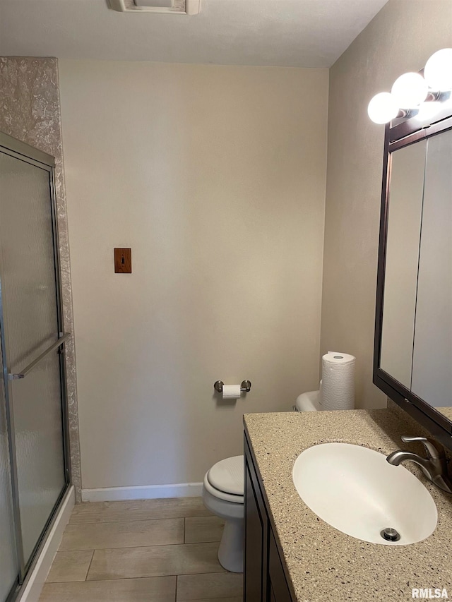 bathroom featuring toilet, walk in shower, and vanity