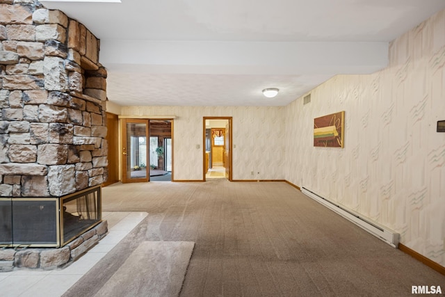 unfurnished living room featuring a fireplace, light colored carpet, and a baseboard radiator