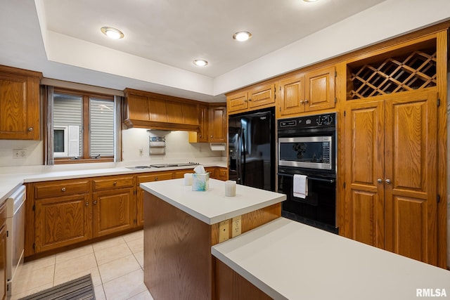 kitchen with black appliances, light tile patterned floors, and a kitchen island