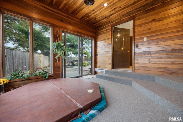 sunroom / solarium with a jacuzzi and wood ceiling