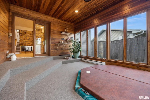 unfurnished sunroom with wood ceiling and a baseboard heating unit