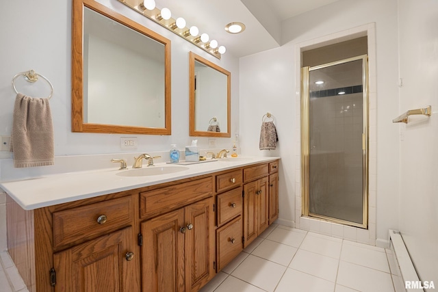 bathroom featuring vanity, a baseboard radiator, tile patterned flooring, and walk in shower