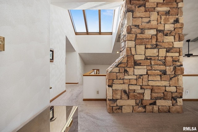 interior space with a high ceiling and light colored carpet