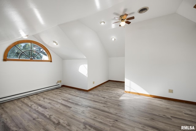 additional living space with light hardwood / wood-style floors, lofted ceiling, a baseboard radiator, and ceiling fan