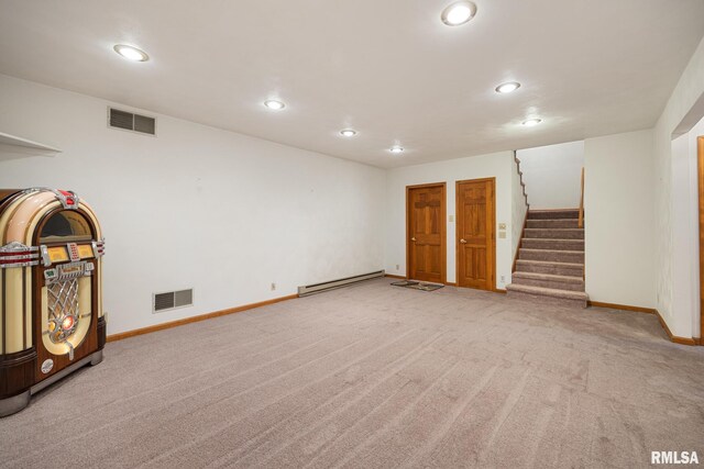 unfurnished living room featuring carpet flooring and baseboard heating