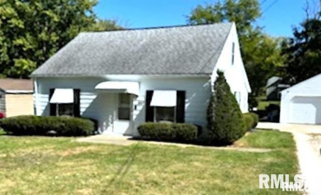 view of front of property with a garage and a front lawn