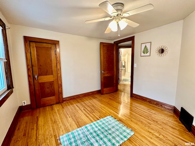 empty room featuring ceiling fan and light hardwood / wood-style floors