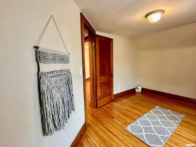 spare room with hardwood / wood-style floors and a textured ceiling