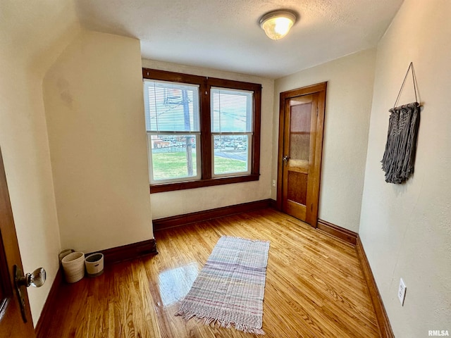 unfurnished bedroom with light hardwood / wood-style floors and a textured ceiling