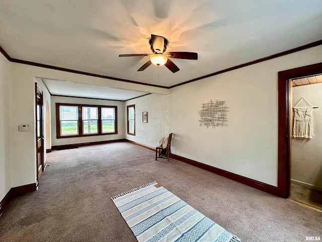 carpeted empty room featuring ceiling fan and crown molding