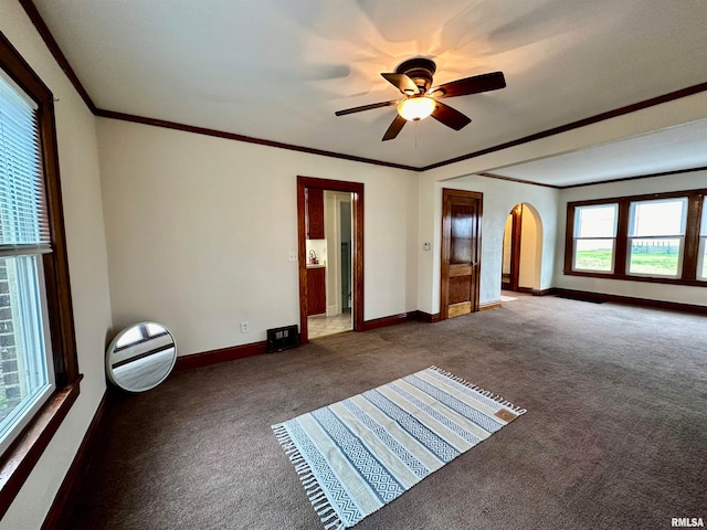 carpeted spare room featuring ceiling fan and ornamental molding