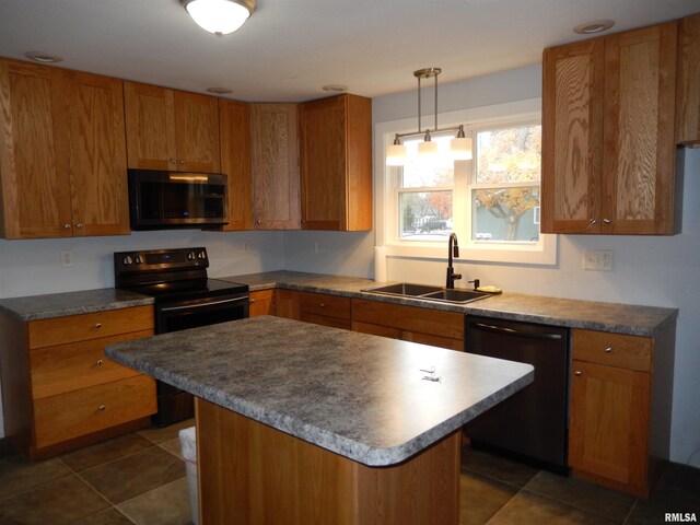 kitchen with black appliances, hanging light fixtures, a sink, and brown cabinets