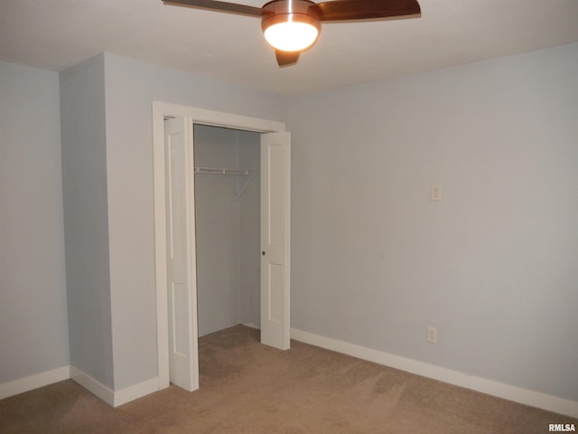 unfurnished bedroom featuring carpet, baseboards, ceiling fan, and a closet