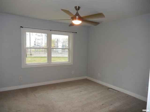 empty room featuring light carpet and ceiling fan