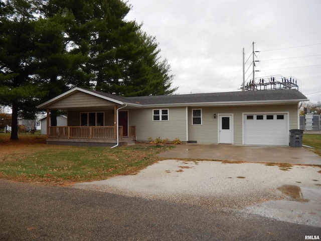 single story home featuring covered porch and a garage