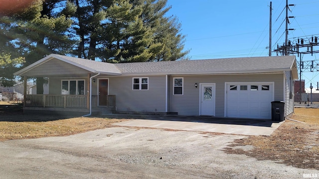 ranch-style home with covered porch, driveway, roof with shingles, and a garage