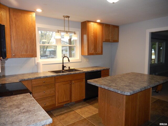 kitchen featuring tile patterned floors, a kitchen island, hanging light fixtures, sink, and black appliances