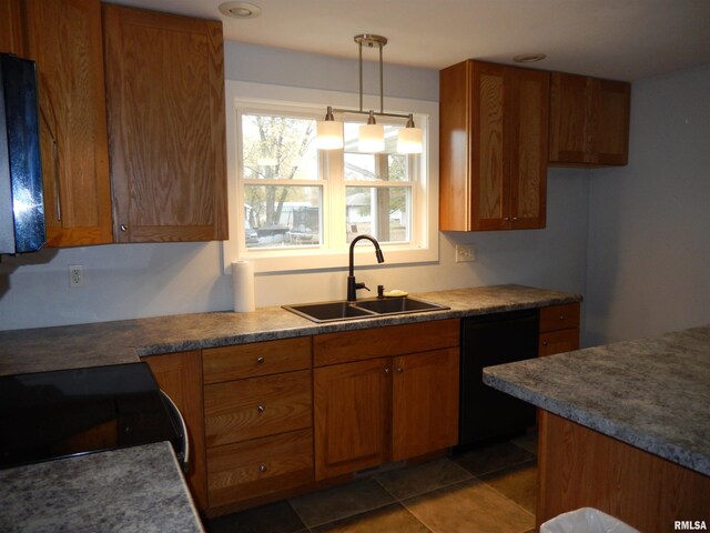 kitchen featuring black dishwasher, sink, range, dark tile patterned floors, and hanging light fixtures