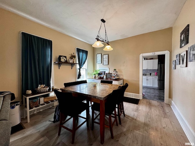 dining space featuring light wood-type flooring