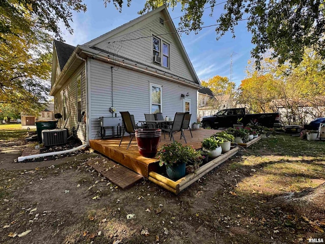 rear view of property featuring central AC and a deck