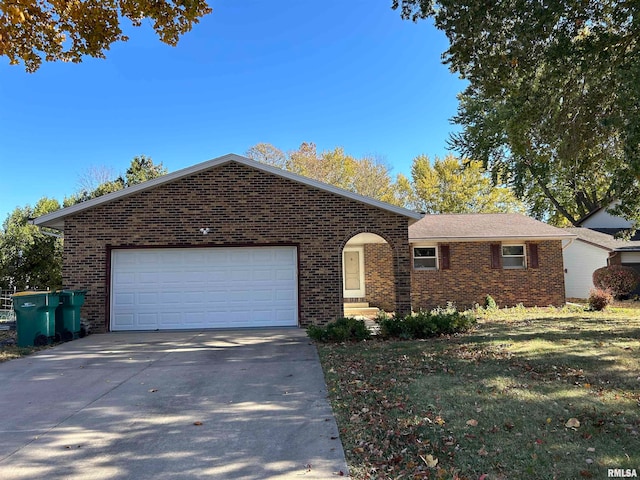 single story home with a front yard and a garage