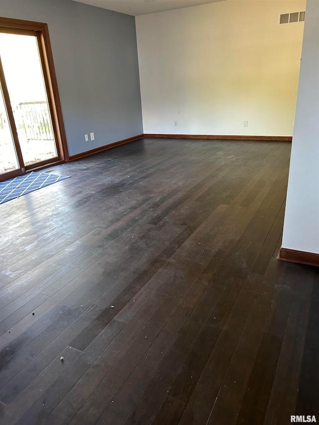 empty room featuring dark hardwood / wood-style flooring