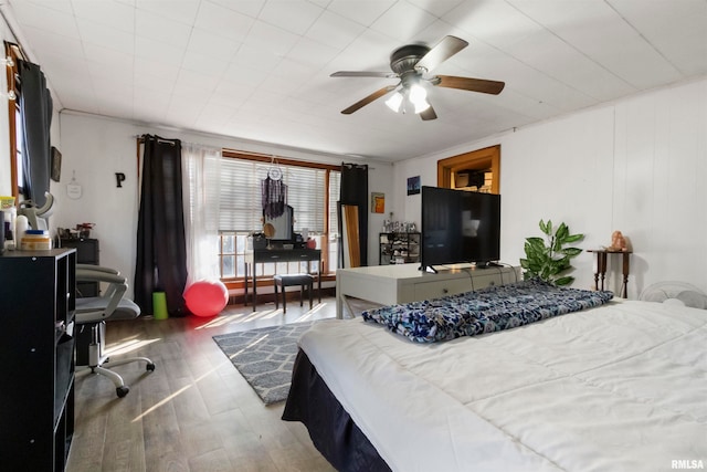 bedroom with hardwood / wood-style flooring and ceiling fan