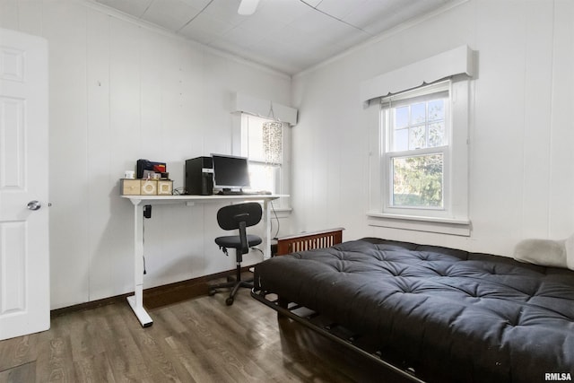 bedroom featuring ornamental molding and dark hardwood / wood-style flooring