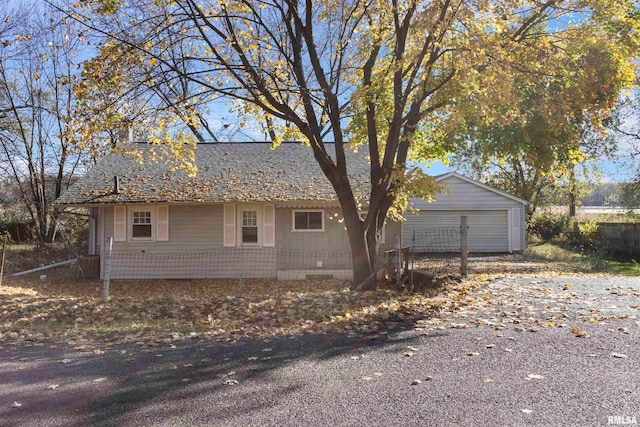 view of side of property with a garage and an outdoor structure