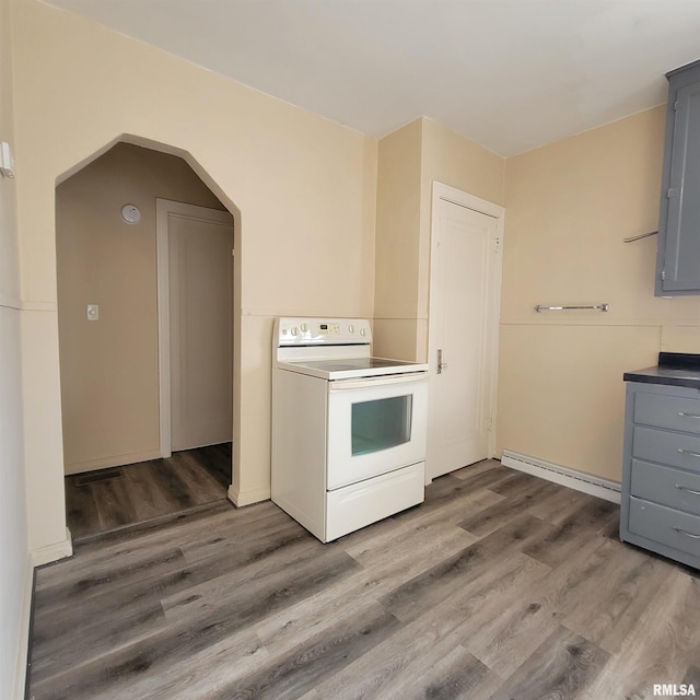 kitchen with white electric range oven, dark hardwood / wood-style flooring, gray cabinetry, and a baseboard heating unit