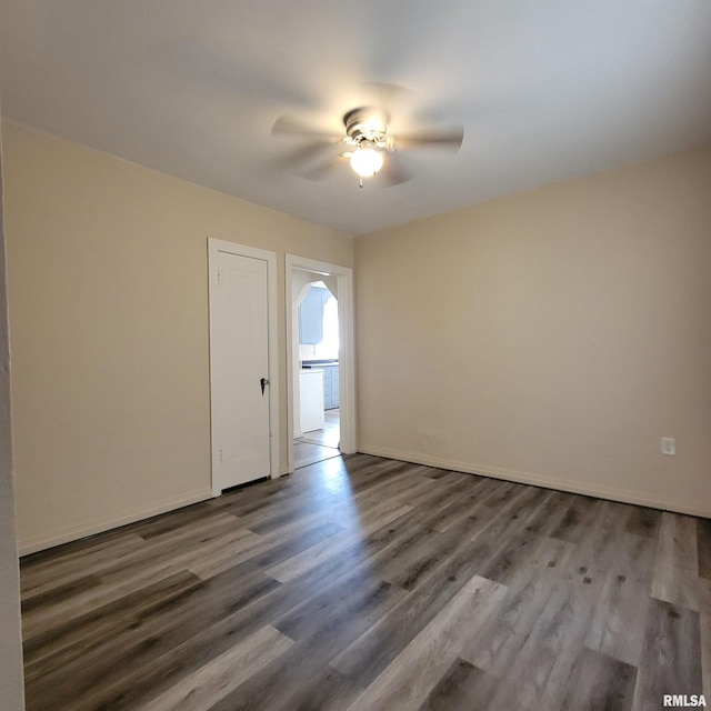 unfurnished room featuring hardwood / wood-style floors and ceiling fan