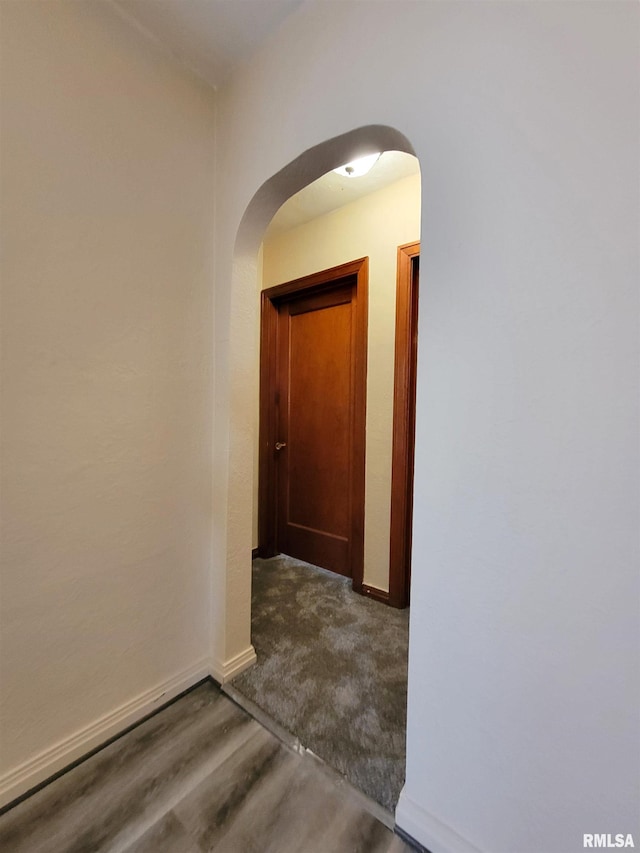 hallway with dark wood-type flooring