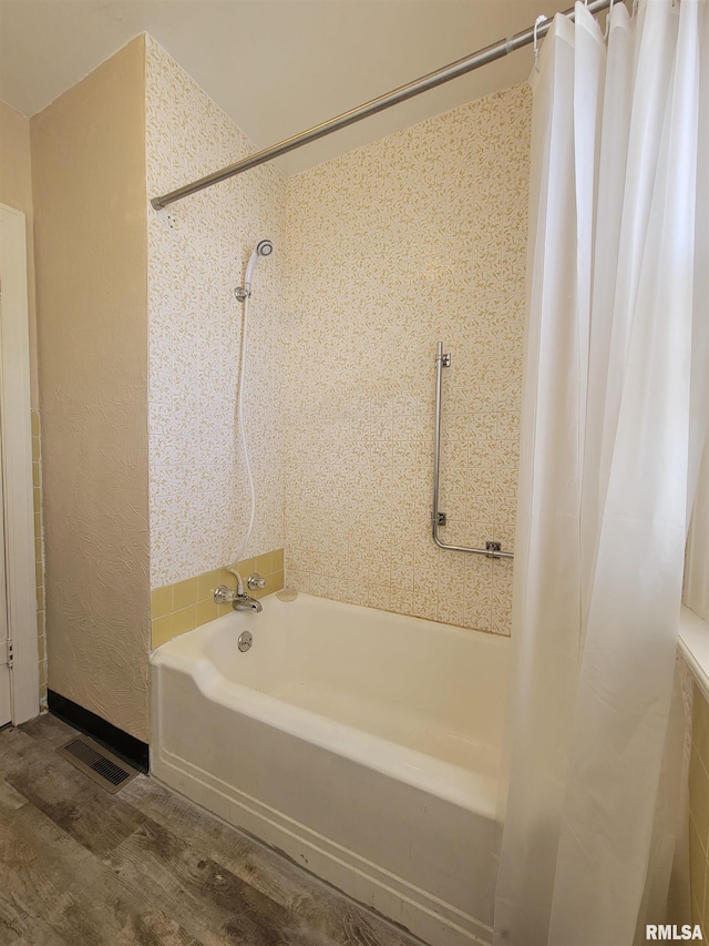 bathroom featuring shower / bath combo and hardwood / wood-style floors