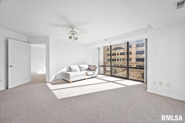 123 SW Jefferson Ave Unit E3S, Peoria, IL 61602 - unfurnished living room with ceiling fan and carpet flooring