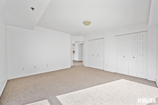 123 SW Jefferson Ave Unit E3S, Peoria, IL 61602 - unfurnished bedroom featuring multiple closets and carpet floors