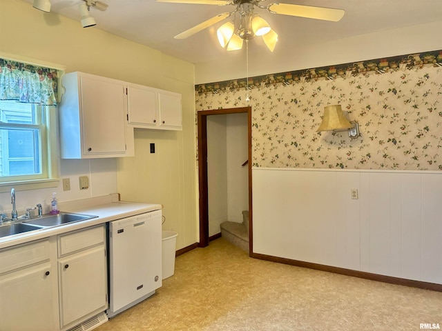 kitchen with white cabinetry, sink, white dishwasher, ceiling fan, and light colored carpet