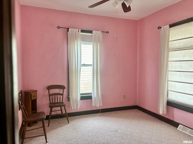 living area featuring ceiling fan