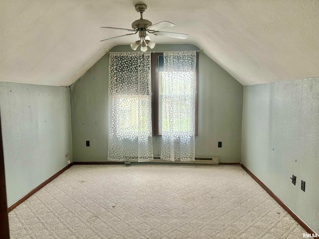 bonus room featuring a textured ceiling, ceiling fan, and vaulted ceiling